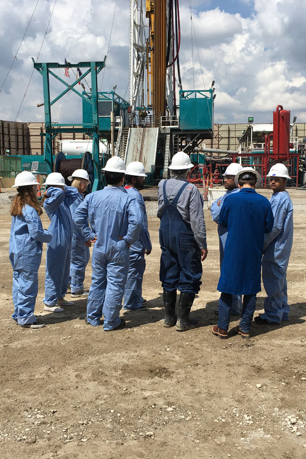 Master's in Energy Management students wearing safety gear at an urban drilling site visit