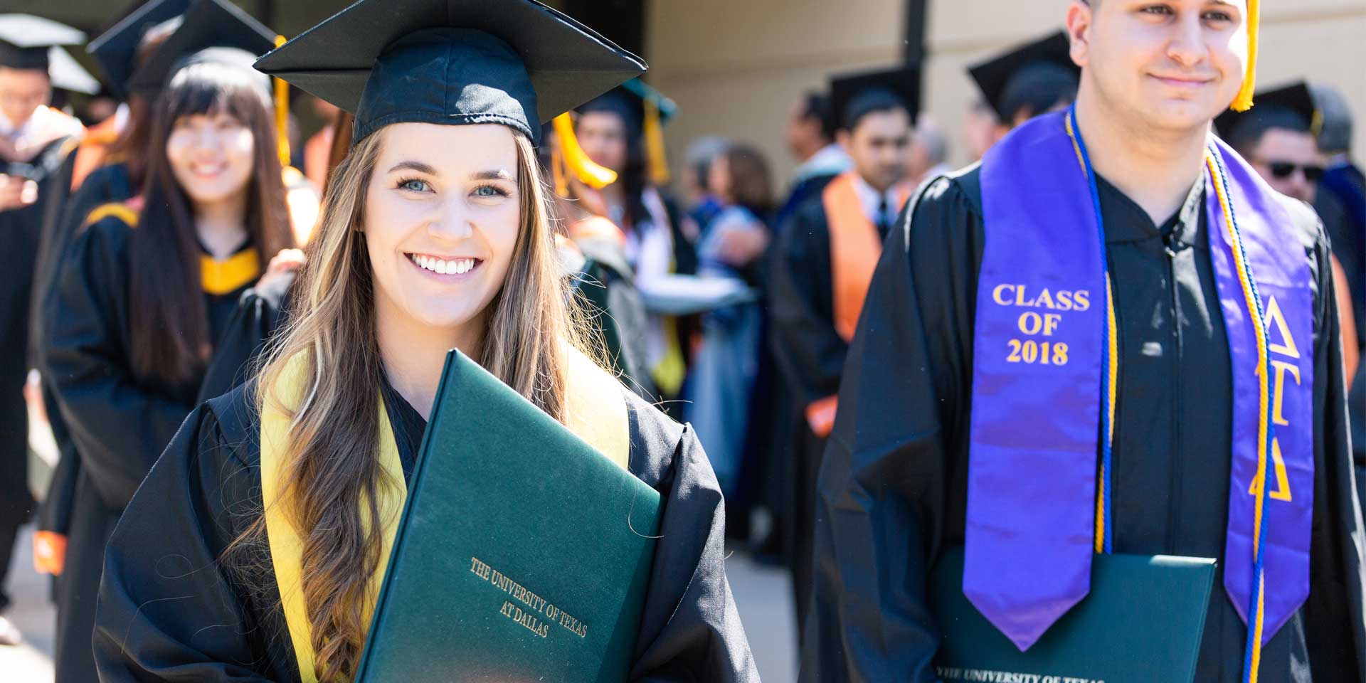 Megan Eckert grins widely after earning her bachelor’s degree in finance.